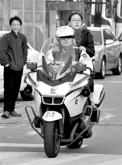 7日，首爾，警察將一名考生送抵考場。新華社發(fā)