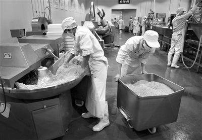 昨日，位于順義李遂開(kāi)發(fā)區(qū)的慶豐包子鋪配送中心生產(chǎn)車(chē)間，工人們正在斬拌胡蘿卜餡料。