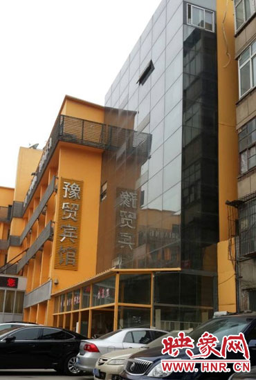 該酒店為加蓋樓層統(tǒng)一安裝上黑色玻璃，從前面看不出加蓋的痕跡