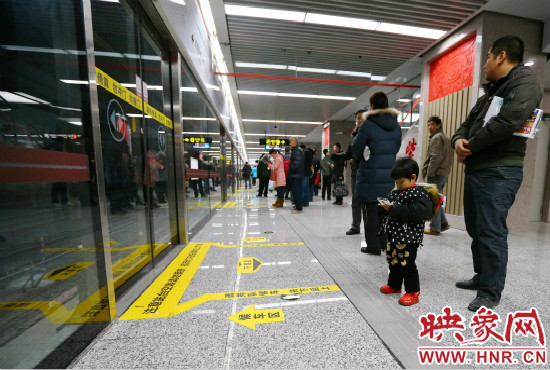 小朋友在等候區(qū)內(nèi)等待地鐵。