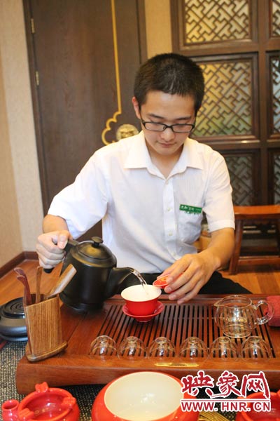 1、水壺里的水煮沸，李克勤把茶葉放進(jìn)茶荷里，準(zhǔn)備溫杯沖茶